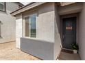 Close-up of a modern home's front door and window with desert landscaping at 36284 W San Clemente Ave, Maricopa, AZ 85138