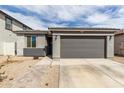 Inviting single-story home with a two-car garage and stone walkway leading to the entrance at 36284 W San Clemente Ave, Maricopa, AZ 85138