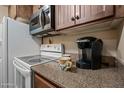 The kitchen features modern appliances, cabinetry, and a coffeemaker at 36601 N Mule Train Rd # 40A, Carefree, AZ 85377