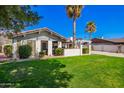 Charming single-story home featuring desert landscaping, a covered carport, and mature palm trees at 4630 W El Caminito Dr, Glendale, AZ 85302
