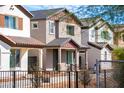 Charming two-story home showcasing desert landscape and architectural details at 470 S Soho Ln # 1, Chandler, AZ 85225