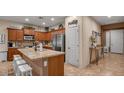 Well-lit kitchen with stainless steel appliances, an island with a breakfast bar and ample cabinet space at 6993 S Ruby Dr, Chandler, AZ 85249