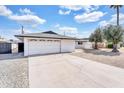 View of home featuring a white exterior, an attached garage, and a concrete driveway at 7745 N 33Rd Ave, Phoenix, AZ 85051
