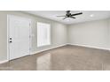 Bright living room with tile flooring, a ceiling fan, and a neutral color scheme at 7745 N 33Rd Ave, Phoenix, AZ 85051