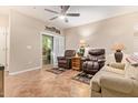 A cozy living room features tile flooring, a ceiling fan, and comfortable furniture at 10136 E Southern Ave # 1082, Mesa, AZ 85209