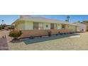 Well-maintained single-story home featuring a decorative rock yard and charming curb appeal at 10319 W Twin Oaks Dr, Sun City, AZ 85351