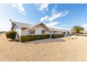 Side view of a well-maintained home with a manicured lawn and neutral colored exterior at 10809 W El Dorado Dr, Sun City, AZ 85351