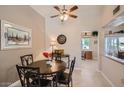 Cozy dining area featuring a ceiling fan, a round table and decorative artwork at 10822 W Mimosa Dr, Sun City, AZ 85373