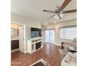 Open-concept living area featuring wood floors, access to the backyard, and neutral color palette at 111 S Greenfield Rd -- # 462, Mesa, AZ 85206