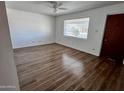 Bright living room featuring hardwood floors, neutral paint, and a ceiling fan at 11223 W Missouri Ave, Youngtown, AZ 85363