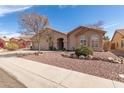 Inviting one-story home with desert landscaping, arched windows, and a two-car attached garage at 11445 S 44Th St, Phoenix, AZ 85044