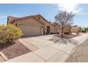 Attractive home with a spacious driveway, desert landscaping, and a two-car attached garage at 11445 S 44Th St, Phoenix, AZ 85044