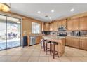 Spacious kitchen featuring an island with seating, stainless steel appliances, and an open layout to the backyard at 11965 W Monte Vista Rd, Avondale, AZ 85392