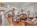 Elegant living room with a Christmas tree, featuring ornate furniture and a staircase with festive garland at 11965 W Monte Vista Rd, Avondale, AZ 85392