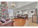 Cozy living room decorated for Christmas, with a high ceiling, decorative furniture, and natural light at 11965 W Monte Vista Rd, Avondale, AZ 85392