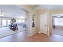 Inviting foyer with tile flooring, open floor plan, and views to the living and dining spaces at 127 S Hancock Trl, Casa Grande, AZ 85194