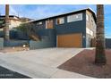 Two-story home with an attached two-car garage and well-maintained landscaping at 1309 E Echo Ln, Phoenix, AZ 85020