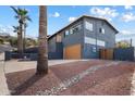 Beautiful gray two-story home with a brown garage door and manicured landscaping at 1309 E Echo Ln, Phoenix, AZ 85020