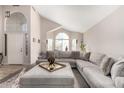 Inviting living room featuring vaulted ceiling, lots of natural light, and a comfortable sectional sofa at 13232 W Ironwood St, Surprise, AZ 85374