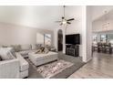 Open-concept living area with a comfortable sectional sofa and a view into the dining space at 13232 W Ironwood St, Surprise, AZ 85374