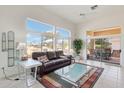 Bright living room with vaulted ceilings, tile flooring, and large windows providing abundant natural light and golf course views at 14110 W Robertson Dr, Sun City West, AZ 85375