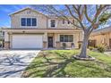 Charming two-story home with well-maintained lawn and mature tree in a desirable neighborhood at 15137 W Yucatan Dr, Surprise, AZ 85379