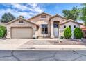 Charming single-Gathering home featuring a well-manicured front yard, a porch and a two-car garage at 17620 W Weatherby Dr, Surprise, AZ 85374