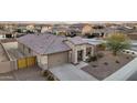 Inviting home with desert landscaping, a two-car garage, and a cozy covered front porch at 18465 W Fulton St, Goodyear, AZ 85338