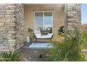 Inviting front porch featuring a cozy bench, decorative pillows, and stylish decor at 18465 W Fulton St, Goodyear, AZ 85338