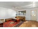 Bright living room with hardwood floors, neutral walls, and an inviting seating arrangement at 2136 W Sharon Ave, Phoenix, AZ 85029