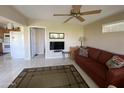 Cozy living area featuring a comfortable red sofa and a view into the adjacent kitchen space at 2315 S Seminole Dr, Apache Junction, AZ 85119