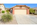 Two car garage with wide driveway and low maintenance front yard landscaping at 23836 W Jefferson St, Buckeye, AZ 85396