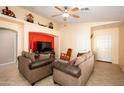 Cozy living room featuring two comfortable sofas, ceiling fan, and an inviting atmosphere at 23836 W Jefferson St, Buckeye, AZ 85396