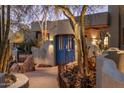 View of front entrance featuring a vibrant blue privacy gate, desert plants, and stone pathway at 25002 N Quail Haven Dr, Rio Verde, AZ 85263