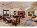 Spacious living room showcasing high wood-beam ceilings and terracotta flooring at 25002 N Quail Haven Dr, Rio Verde, AZ 85263