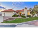 Beautiful single-story home showcasing a red tile roof, lush greenery, and warm exterior lighting at 2514 E Montebello Ave, Phoenix, AZ 85016