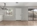 Bright living room featuring neutral walls, tile flooring, and natural light at 286 W Palomino Dr # 101, Chandler, AZ 85225