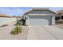 Attached two-car garage with a concrete driveway and low-maintenance landscaping at 39935 N Passaro Dr, San Tan Valley, AZ 85140