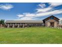 Bella Vista Farms clubhouse with stone and barn accents and large grassy area in front at 4185 E Kolin Ln, San Tan Valley, AZ 85143