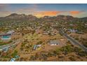 Breathtaking aerial view of the desert community with mountain views at sunset at 4188 N Plaza Dr, Apache Junction, AZ 85120