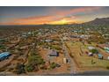 Expansive aerial view showcasing the desert community at sunset, highlighting its scenic location at 4188 N Plaza Dr, Apache Junction, AZ 85120