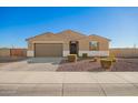 Inviting single-story home showcasing desert landscaping and a two-car garage, complemented by a well-manicured lawn at 4459 E Warlander Ln, San Tan Valley, AZ 85140