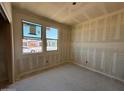 This bedroom shows the installation of drywall and two windows providing natural light at 46886 W Old Timer Rd, Maricopa, AZ 85139