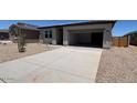 Charming single-story home showcasing a spacious driveway and low-maintenance desert landscape at 46886 W Old Timer Rd, Maricopa, AZ 85139