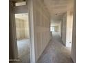 Hallway with newly installed drywall that leads to a living space with natural light at 46886 W Old Timer Rd, Maricopa, AZ 85139