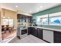 Cozy kitchen with stainless steel appliances, tile flooring, and ample counter space at 5915 E Fairfield St, Mesa, AZ 85205