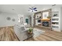 Spacious living room with a fireplace, ceiling fan, and neutral tones at 6993 S Roger Way, Chandler, AZ 85249