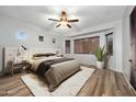 Bright main bedroom with a ceiling fan, lots of natural light and wood-look flooring at 6993 S Roger Way, Chandler, AZ 85249