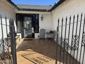 Inviting front porch featuring tile flooring, wrought iron accents, and comfortable seating perfect for relaxing at 7350 E Pueblo Ave, Mesa, AZ 85208