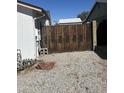 Side yard with gravel and wooden fence at 7350 E Pueblo Ave, Mesa, AZ 85208